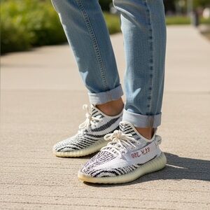 This is an Adidas Yeezy Boost 350 V2 'Zebra' sneaker